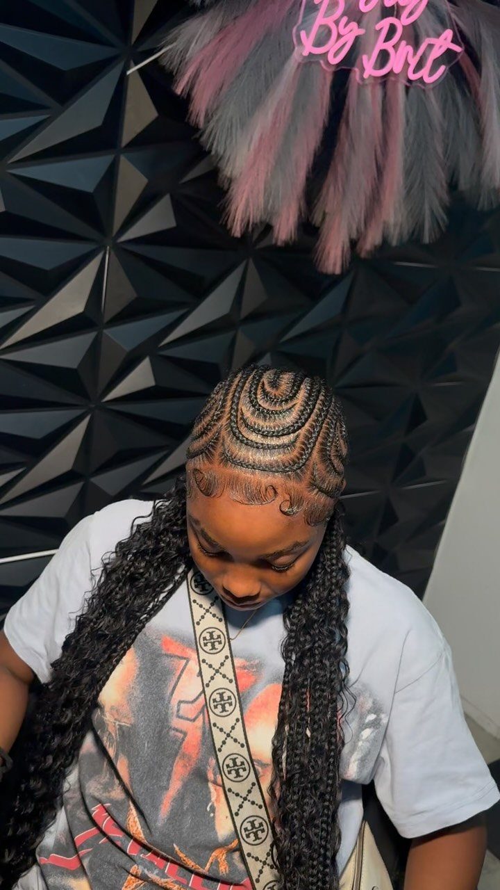 Person with intricate cornrows on the scalp transitioning into long hanging braids.