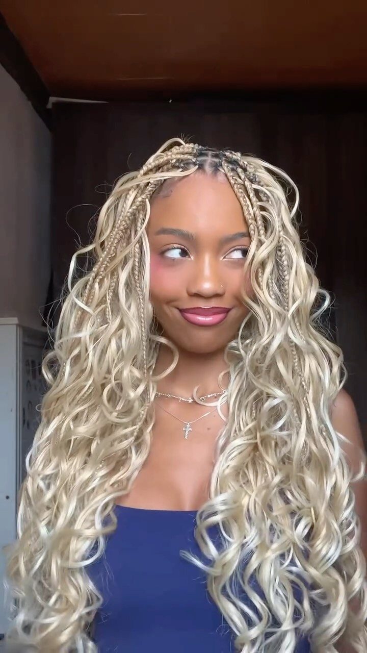 Woman with blonde French curl braids featuring loose curls at the ends.