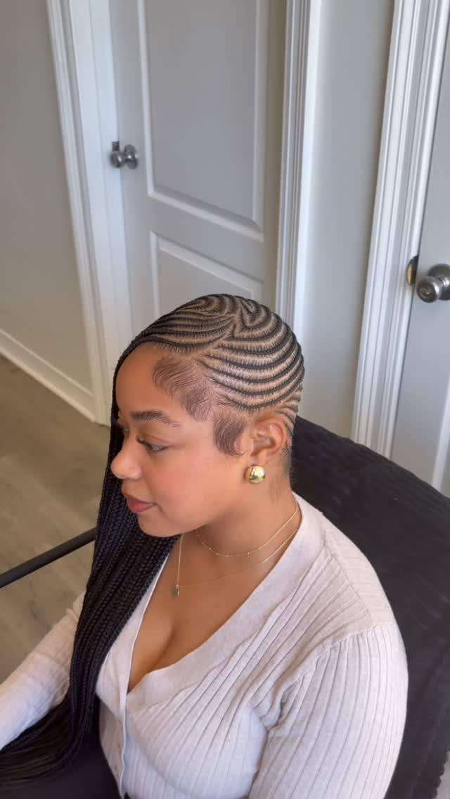 Woman with long lemonade braids styled in a deep side part and cornrows.